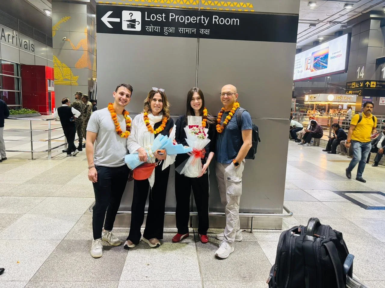 Travelers receiving a garland welcome at the airport