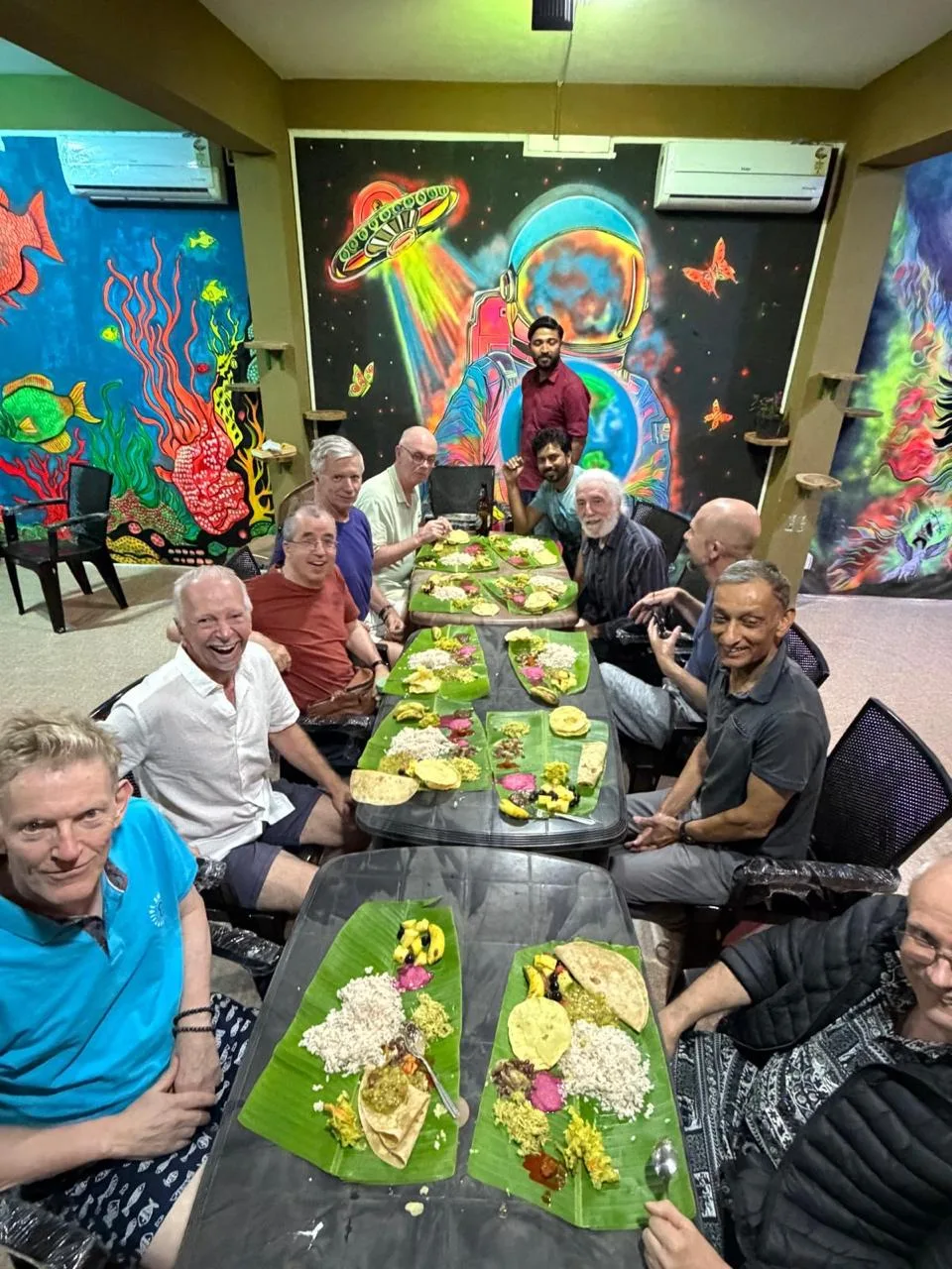 Travelers gathered around a long dining table